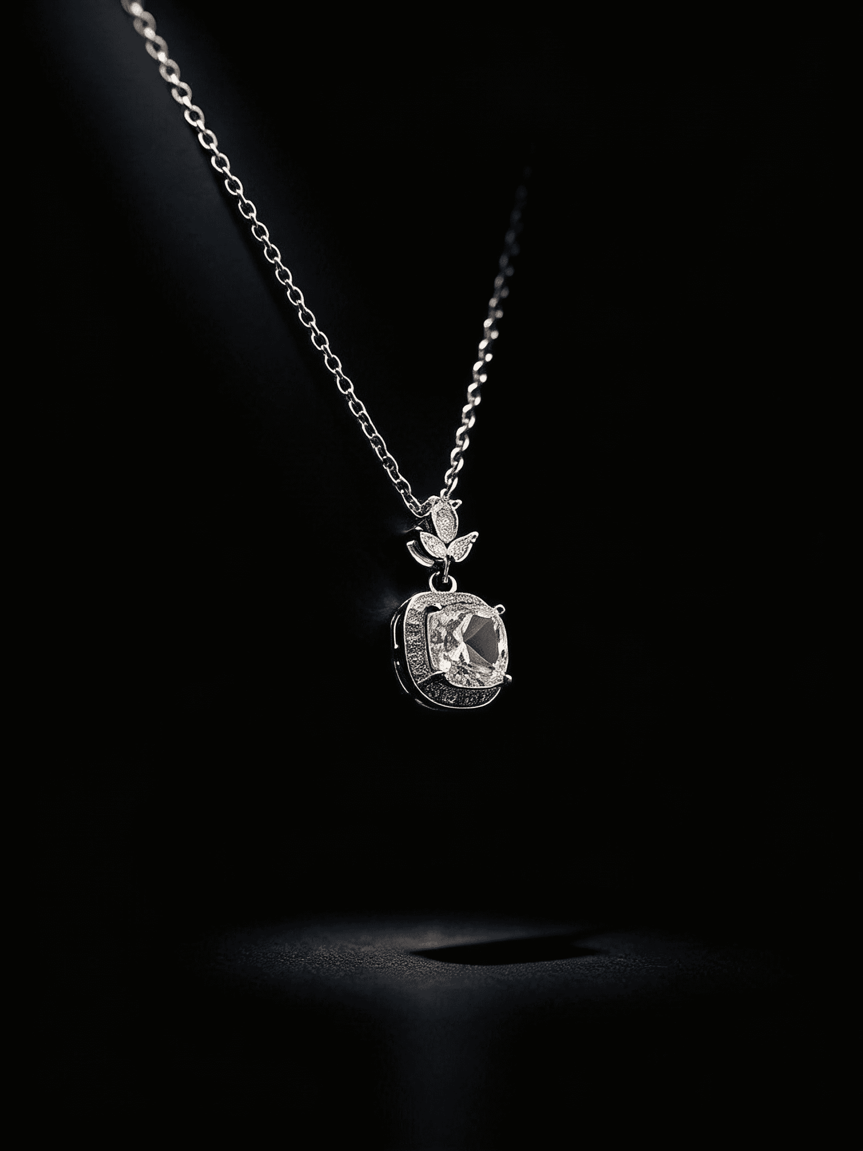 Silhouetted model wearing diamond ring and drop earrings, lit by warm golden light against a dark background